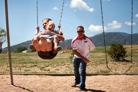 A former Marine pushes his wife and daughter on a swing. (Photo: U.S. Marine Corps/Lance Cpl. Chelsea Flowers)