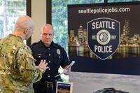 A Joint Base Lewis-McChord soldier speaks with a Seattle Police Department recruiter at a networking and hiring event at the American Lake Conference Center, May 11. (Photo by Staff Sgt. Bryan Dominique)