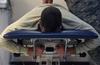 FILE PHOTO – An airman lies on a table for a back treatment.