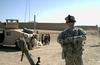 Brian Thompson laughs near local children while on patrol in Afghanistan