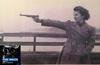Women's Army Corps troop aiming a pistol