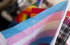 Transgender pride flag is displayed at a booth during Portland Pride