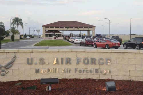 Privately owned vehicles wait to enter through the Dale Mabry gate at MacDill Air Force Base.