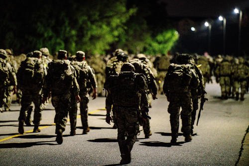 Paratroopers across the 82nd Airborne Division execute the 12 mile road march