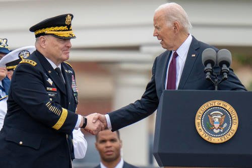 President Joe Biden, right, shakes hands with outgoing Joint Chiefs Chairman Gen. Mark Milley