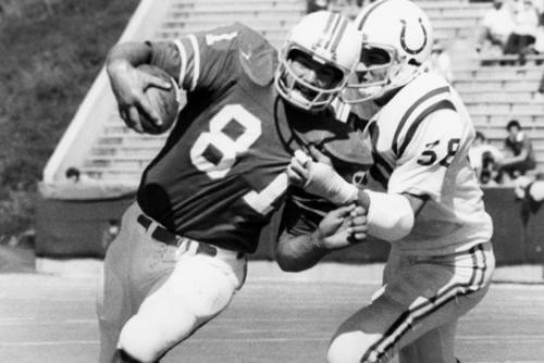 New England Patriots tight end Russ Francis charges ahead for 4 yards as the Baltimore Colts' Derrel Luce tries to bring him down during the 2nd quarter of an NFL game in Foxboro, Mass.