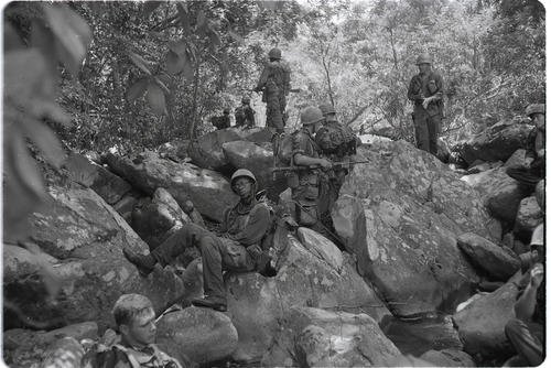 Marines of Company L, 3rd Battalion, 5th Marines, take a rest on rocky terrain near Dong Ha during Operation Hastings in Vietnam, July 1966.