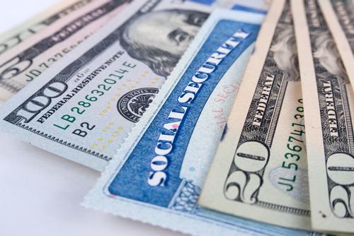 Social security card and American money dollar bills close up concept