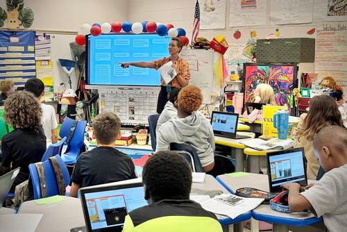 A teacher engages her 5th grade students in an interactive lesson at Kessler Elementary School