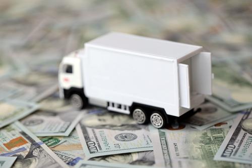toy moving truck on scattered cash