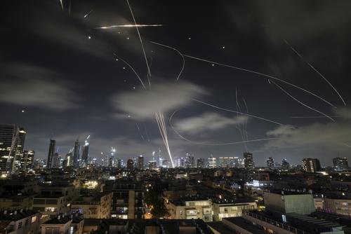 The Israeli Iron Dome air defense system fires to intercept missiles during an Iranian attack over Tel Aviv, Israel