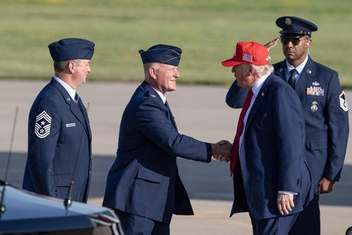 President Donald J. Trump is greeted by Col. Travis Crawmer (center), 132d Wing commander, and Chief Master Sgt. Jason Lehmann (left), 132d Wing command chief, during an official visit to Iowa, July 3, 2025, at the 132d Wing in Des Moines, Iowa.