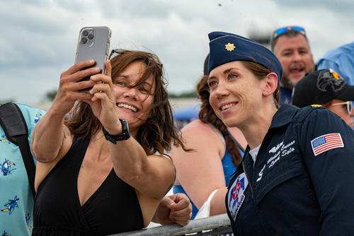 Maj. Michelle Curran, United States Air Force Air Demonstration Squadron ‘Thunderbirds’ lead solo pilot, takes a photo with a fan after performing at the Great Tennessee Air Show in Smyrna, Tennessee.