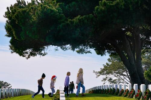 Volunteers place holiday wreaths at Fort Rosecrans cemetery.