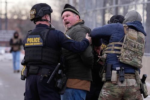 Law enforcement detain a man outside the Bishop Henry Whipple Federal Building during a protest on Saturday, Jan. 17, 2026, in Minneapolis. (AP Photo/Yuki Iwamura)